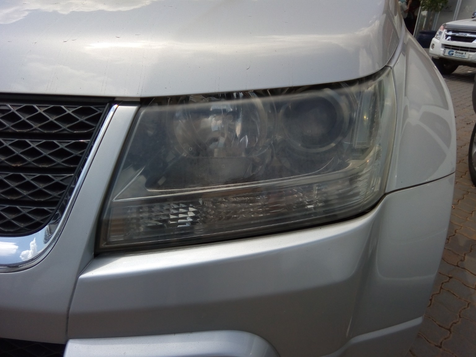 Cloudy SUV headlight before restoration